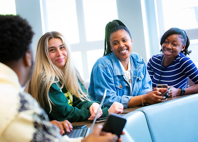 Students sitting together smiling