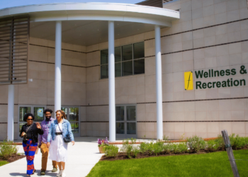 Students and Staff walking in front of the Wellness & Recreational Center (WARC)