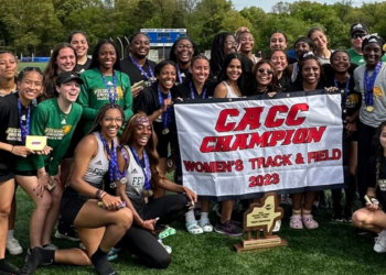 Women's Track & Field Team Picture Holding Up CACC Banner