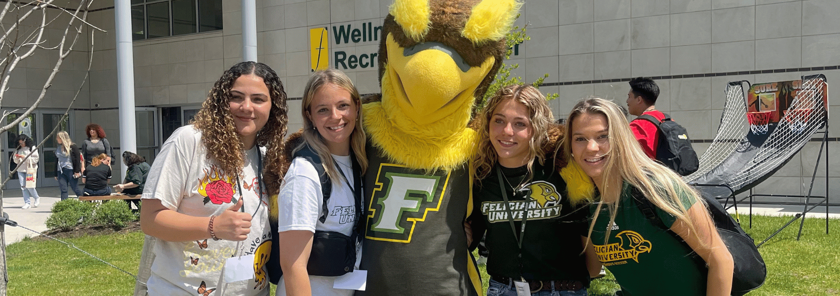 Frankie the Falcon with a group of female students at admitted students day