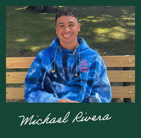 Student Michael Rivera sitting on bench 