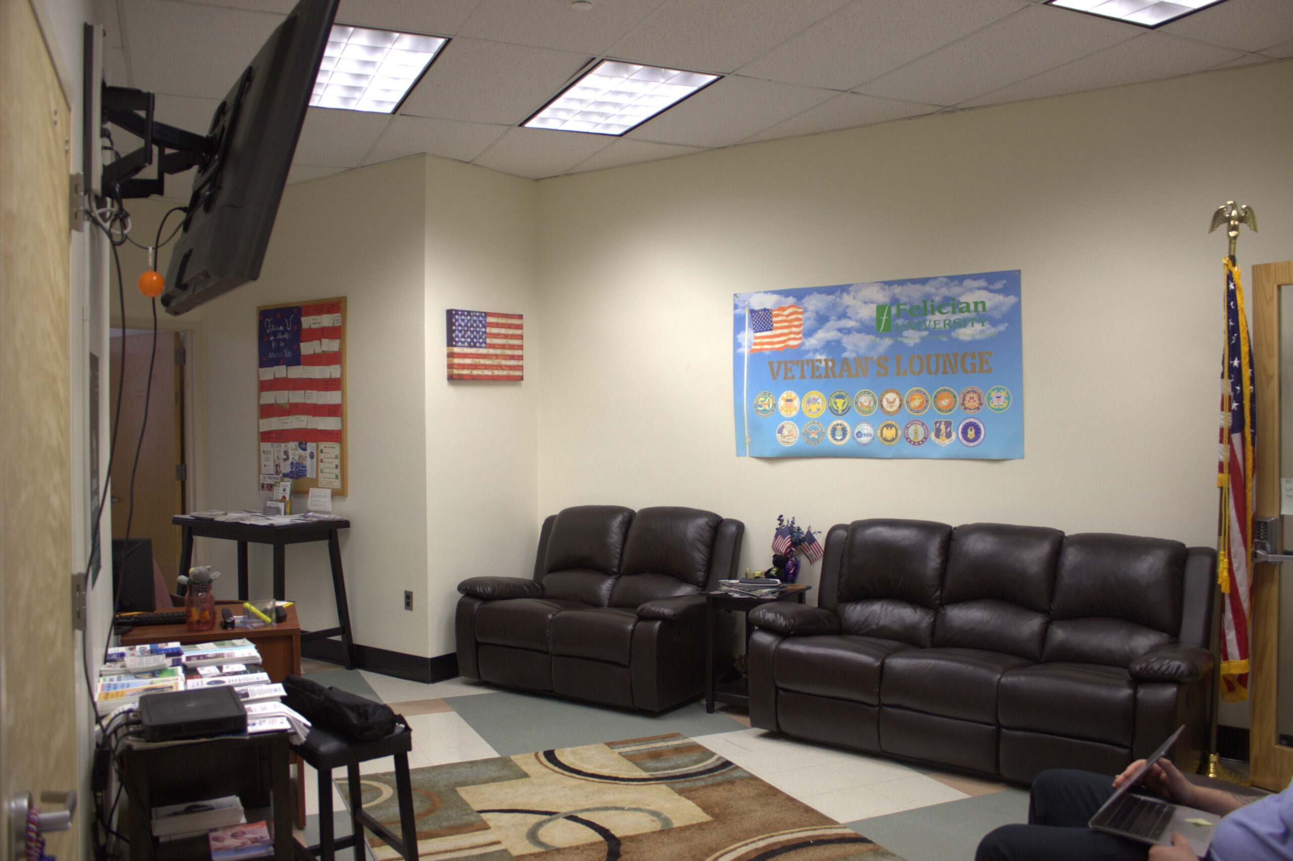 veteran's lounge with couches and a flag