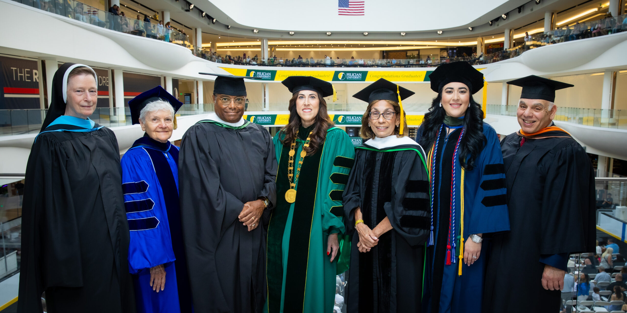 president mildred with faculty at graduation